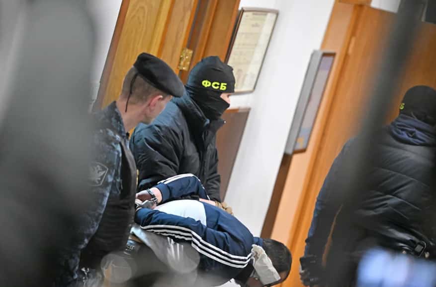 Four men with signs of severe beating charged with terrorism by Moscow court in Crocus City Hall case