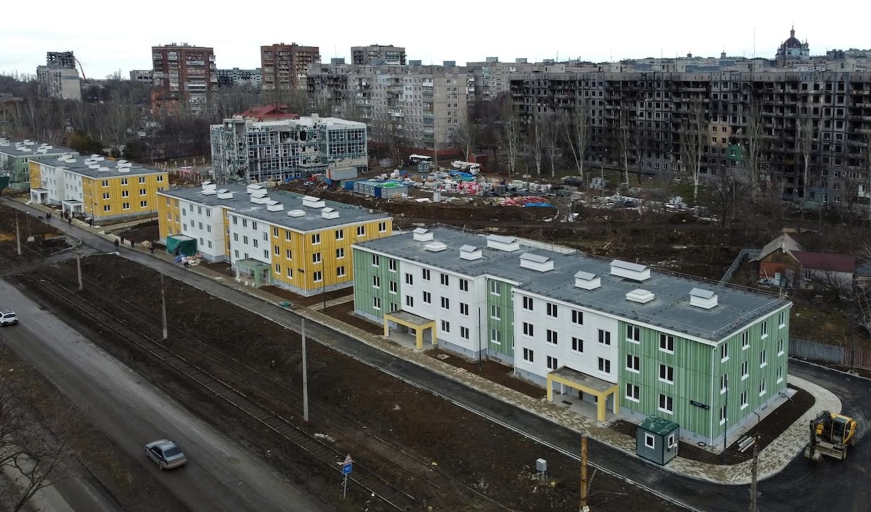 Restored facades against a backdrop of destruction in Mariupol