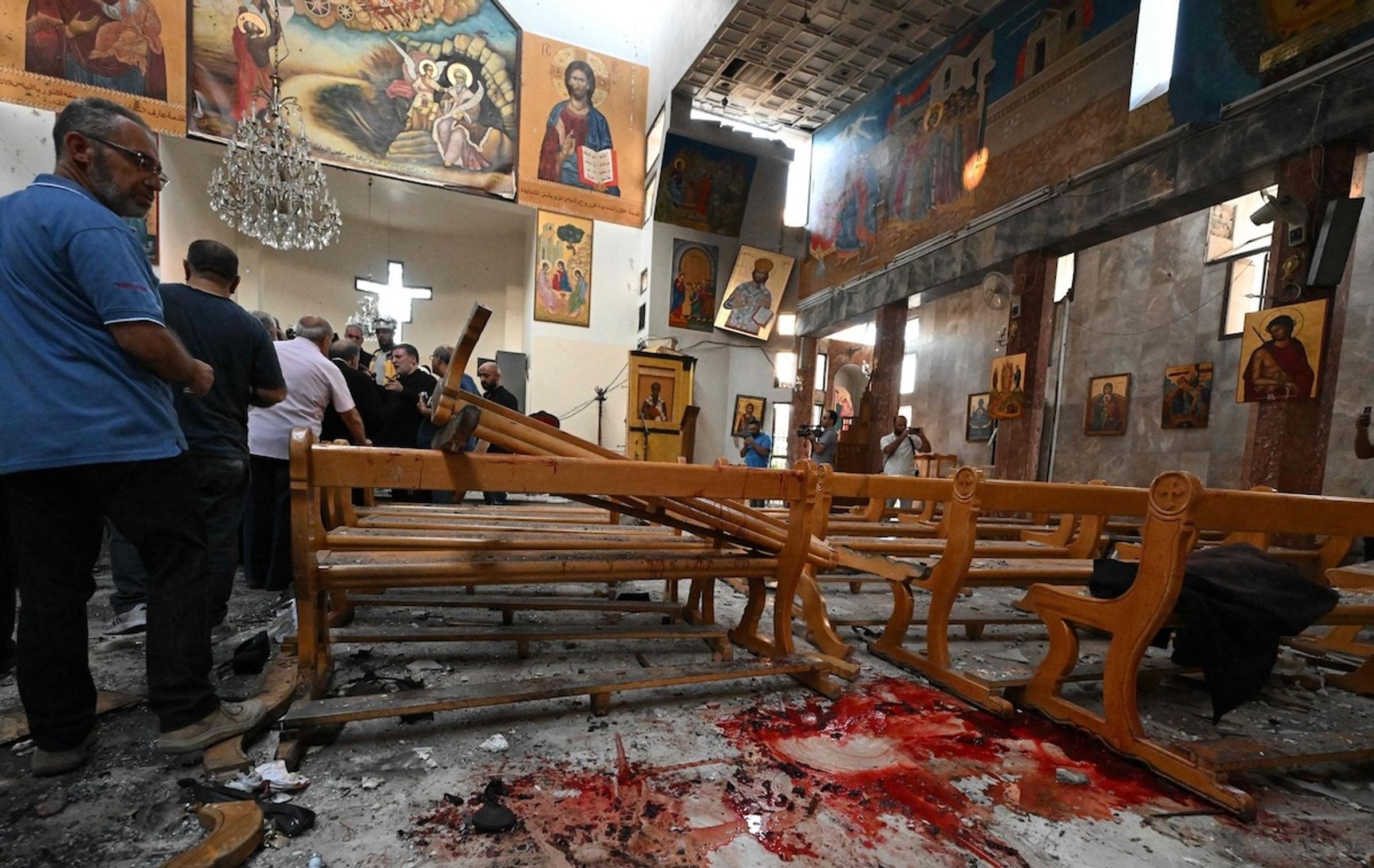 A churchgoer looks at the aftermath of a bombing at Mar Elias Church.